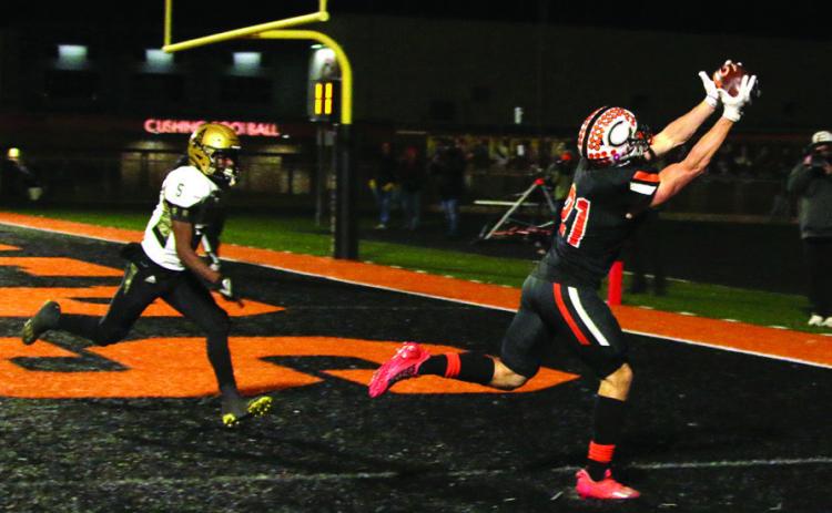 Camden Crooks catches a perfect pass from quarterback Blaze Berlowitz for another Cushing touchdown Friday. Photo by J. D. Meisner