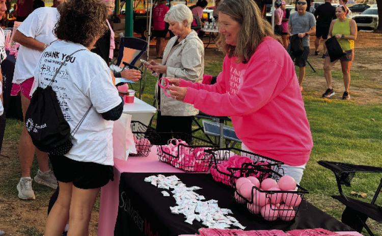 Pictured at the Enid breast cancer awareness event, Shyla Eggers promotes Stillwater Medical Center. After years of helping share patient stories, Eggers recently found herself navigating her own health journey with sleep apnea.