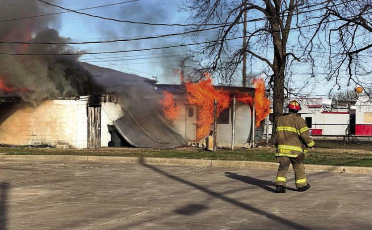 Cushing Fire Captain Tyler Morris, among the first to arrive at the scene, takes an assessment to help plan his department’s attack strategy. Photo by J. D. Meisner