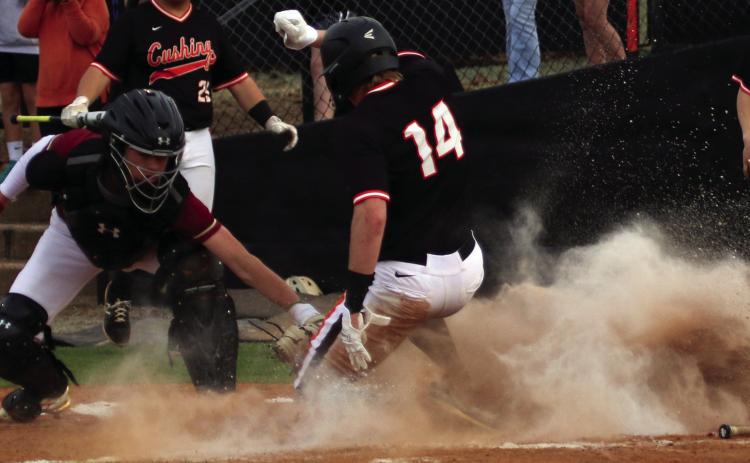 Statler Ethridge slides into home while dodging the Lincoln Christian catcher’s glove. Photos by Allie Prater