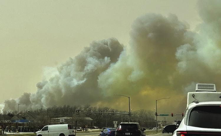 Wildfires burn thousands of acres, dozens of homes