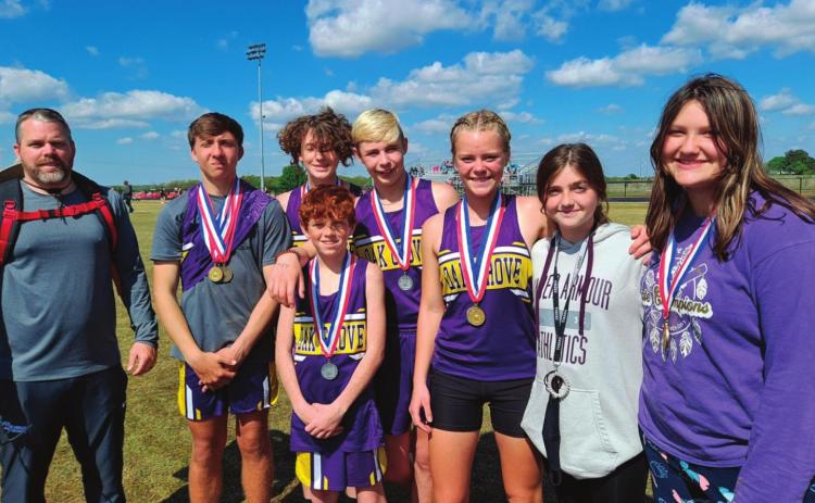 Oak Grove’s Track team came home from the recent ORES State Track meet with three state champs and a lot of podium finishes. Pictured rom left are, Coach Nate Walker, Klayton Kinnin, Tony Six, Cole Cooper, Cora Eyler, Mya Bridgeman, and Hailee Allen. In the front is Owen Collier.