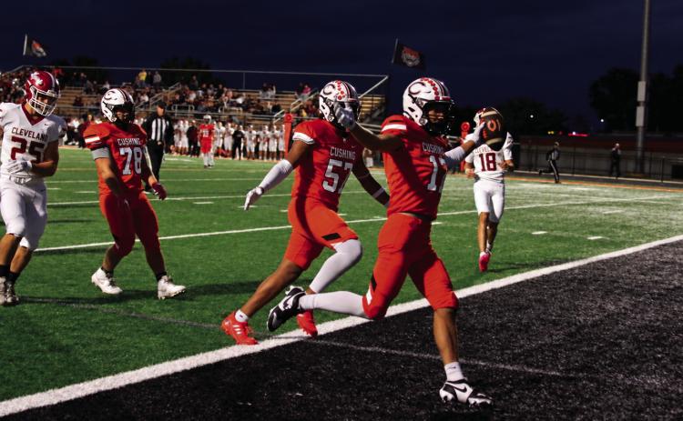 Cushing’s Gage Sharp celebrates as he crosses the goal line Thursday for the first of Cushing’s eight TD’s. Photo by J. D. Meisner