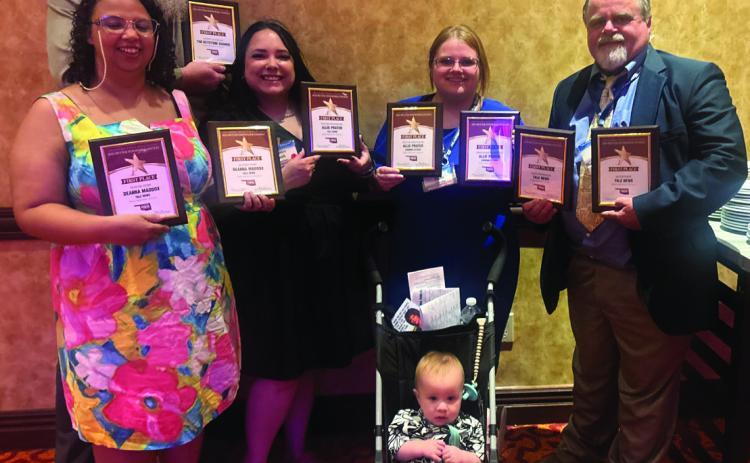 Cimarron Valley Communications staff stand with their first place plaques following the Better Newspaper Contest awards banquet Saturday, June 6 held at the Embassy Suites in Norman. Pictured back row advertising director Jeremy Fincher, middle row lead reporter DeAnna Maddox, accounts and office manager Sapphire Smith, managing editor Allie Prater, owner and publisher J.D. Meisner, front row chief moral officer Jamison Prater. Photo by Caleson Coon.