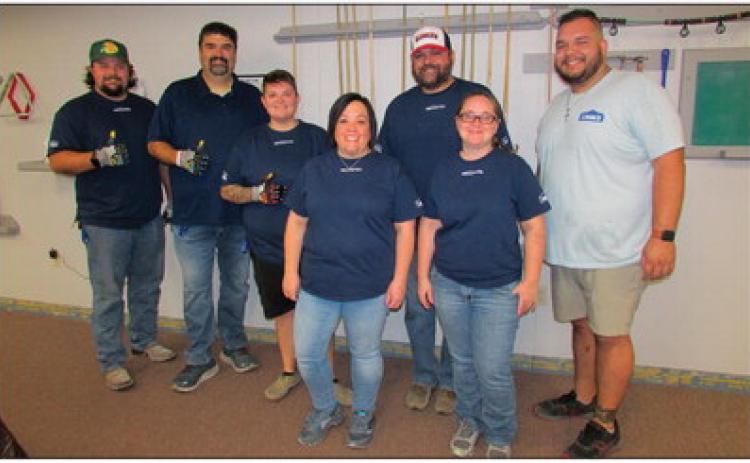 Volunteers came to the Cushing Senior Citizen Center as part of Lowe’s Red Vest Volunteer Day last Friday to provide updates such as installing new baseboards to match the new coat of paint throughout the building.