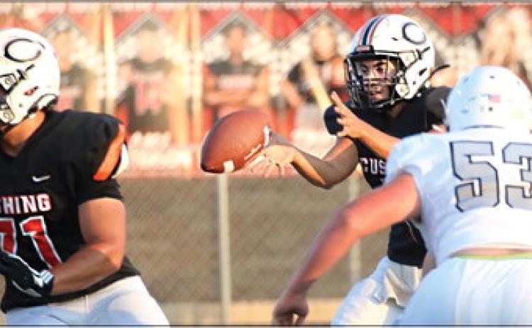 Cushing Tiger Quarterback John Hilligos takes the snap. Photos by Allie Prater.