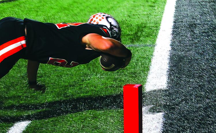Wyatt Heisler makes a diving touchdown in the second quarter of last weeks win over Ft. Gibson. Photo by J. D. Meisner