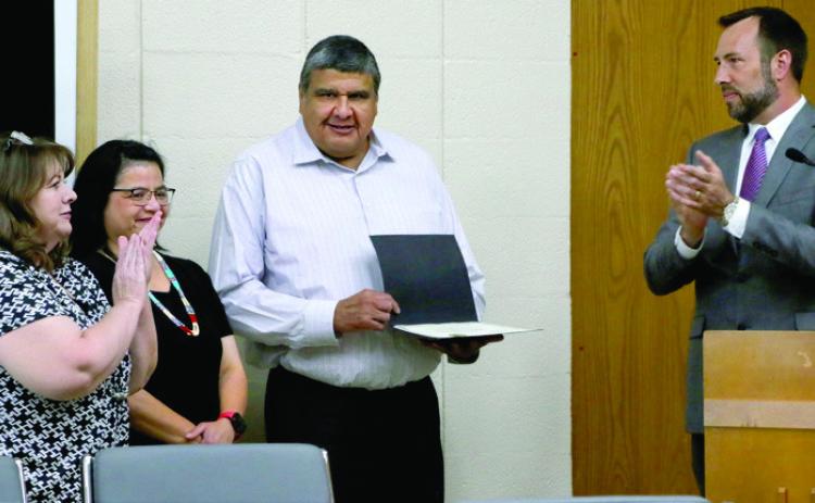 City of Cushing employee Brett Youngman stands with his wife Lavonda after he is presented with a team member recognition award by Tracy Rose from Oklahoma Municipal League and Commission Chairman B.J. Roberson during the commission meeting Monday, June 17, Photo by Allie Prater.