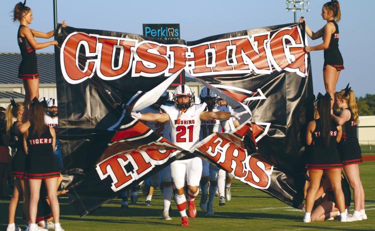 Tiger receiver Camden Crooks breaks through the signs at Perkins Friday