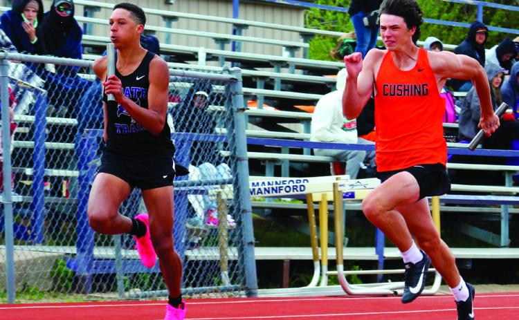 Mannford’s Ryan Owens and Cushing’s Brison Stewart go head-tohead in the 4x100 meter relay.