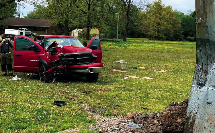 Members of the Cushing Fire Department and EMS work the scene of a truck vs power pole accident in Ninth Street last week. The driver of the truck was seriously injured and flown to OU Medical Center in Oklahoma City. Photo by J.D. Meisner