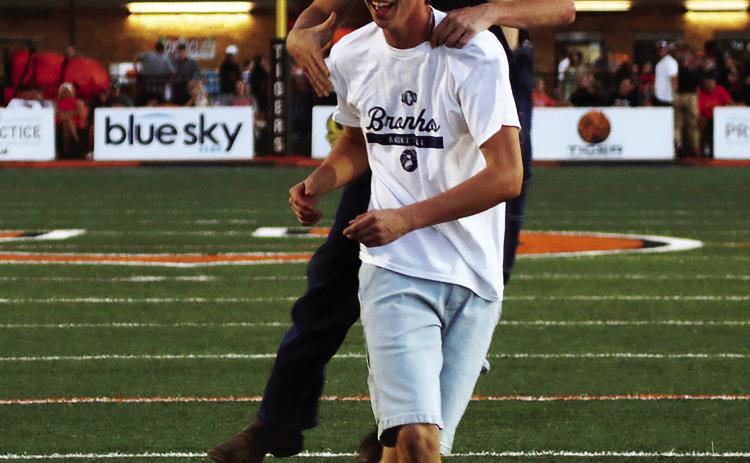 Maddox Morris is congratulated by Jake Collier after Morris successfully kicked a field goal during the Golden Chick’s “Kickin’ for Chicken” contest at halftime of Friday’s Berryhill game. Morris won a 12-piece chicken for his efforts and Collier, who was the holder, probably got a couple pieces. Photo by J. D. Meisner