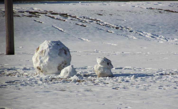 Time honored tradition of building snowmen