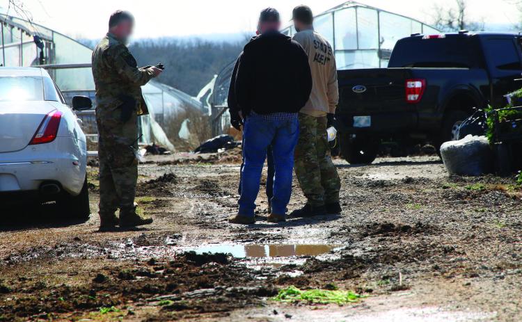 Oklahoma State Bureau of Narcotics agents working the crime scene during a raid of an illegal marijuana grow farm on SH-51 just west of Yale. Photo by Allie Prater.