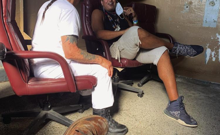 Cushing alumnus Dan Warrior, sits with Danny Trejo in the middle of the production of upcoming movie “Seven Cemeteries”. Warrior will play the role of a henchmen who throws a zombified Efren Ramirez into a wood chipper.
