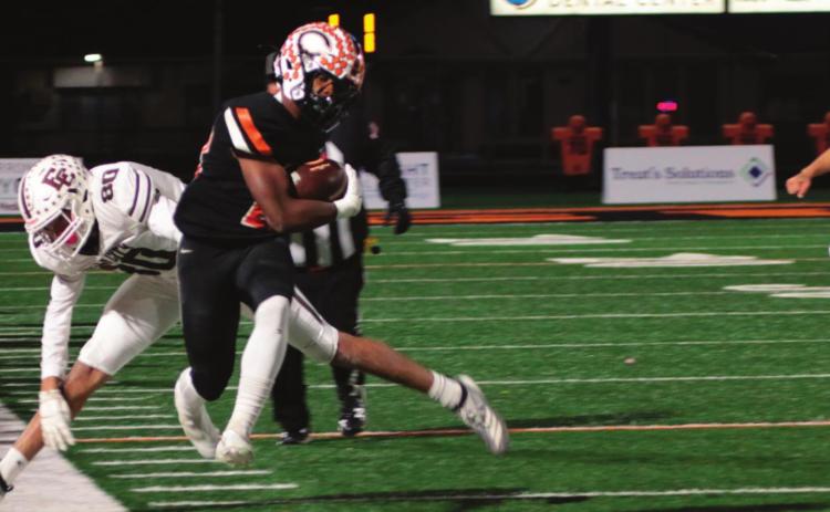 Noah Jones leaps to stay inbounds as he heads up the sidelines.