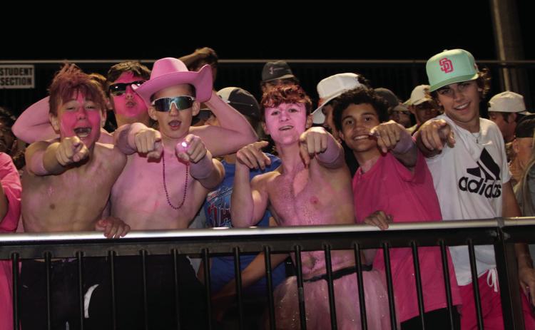 Tiger fans Jagger Willing, Cole Vaughn, Clay McKiddy, Andy Collier, Daniel Hernandez, and Gage Lovin celebrate Cushing’s third touchdown of the night as the Tigers shut out Wagoner Friday during the Breast Cancer Awareness, pink-out game.