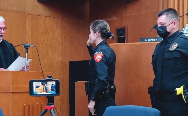Officer Heather Snow is sworn in by Judge Ahrberg while Officer Jason Beal awaits his swearing in during the City of Cushing commissioner meeting on Monday, Sept. 20.