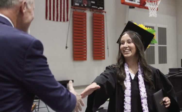 Amber Fausto shakes hands with CHS Principal Bob Coates after receiving her diploma.