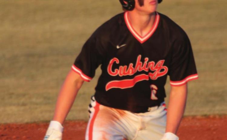 Tiger runner Chantz McBride watches a fly ball from second base Thursday in the Tigers’ home opener against the Tecumseh Savages.