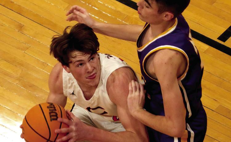 Lane Yaunt muscles up a shot in the paint. Photo by J.D. Meisner