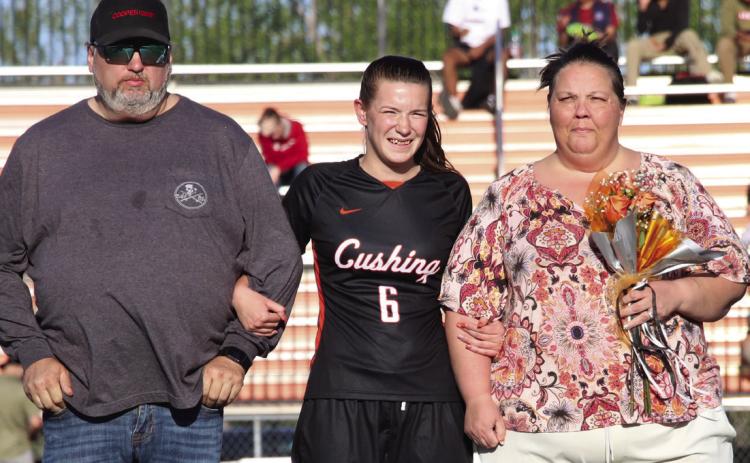 Forward for the Lady Tigers, Kathy Ragen escorted by her parents Gerald and Amanda Regan.