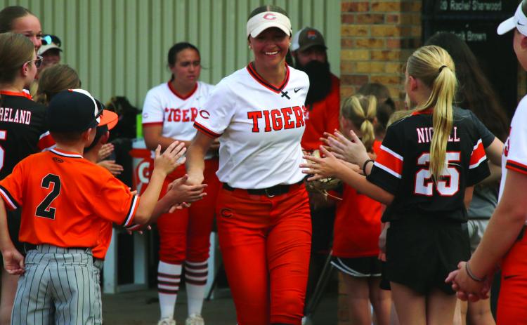 Freshman Talyn Minney is all smiles as she is welcomed onto the field by Cushing Tiger youth athletes. Photo by Allie Prater.