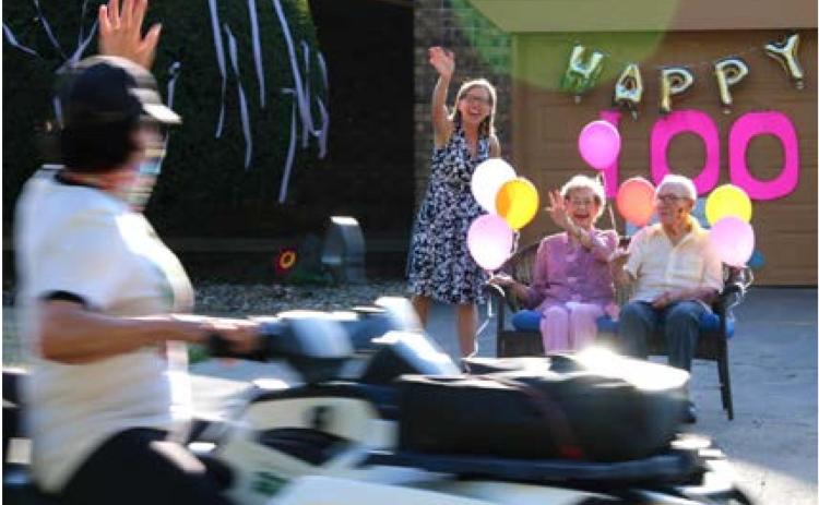 Cathy Reimeck, Hazel Cusac and Jake Amberg enjoy Hazel’s 100th Birthday parade.