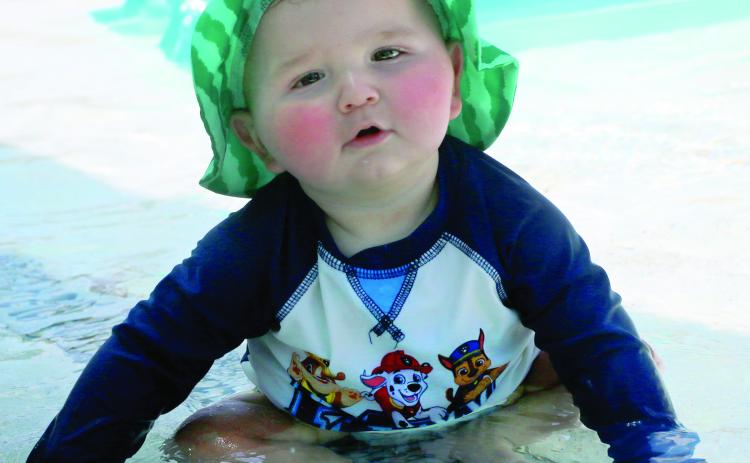 Sun kissed nine month old Abel Viator splashes in the kiddie pool at the Cushing Aquatic Center Monday, June 1. Photo by Allie Prater