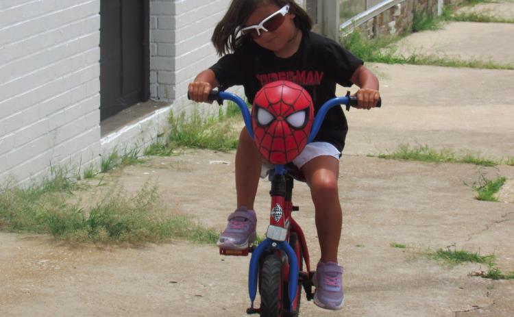 Ainsley flys down the sidewalk at the corner of Broadway and Cleveland — her family was following behind her as they enjoy a sunny day in the Downtown Cushing area. Photo by DeAnna Maddox