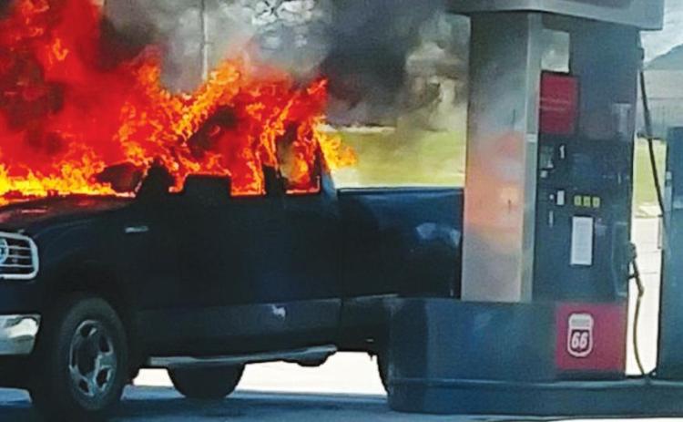 A truck burns at the Yale Mini Supermarket Wednesday after being allegedly set ablaze by its owner.