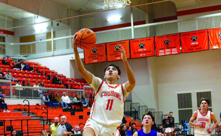 Kanaan Guerrero drains a bucket in transition during the Cushing Tigers defeat of the Mannford Pirates. Guerrero hit the paint hard Friday, scoring 24 points on eight twos and going 8-9 at the free-throw line.