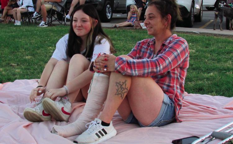 Reanna and Annie Lansford grabbed a blanket and took a spot in the grass to watch the firework display put on by Cushing Fire Department in Memorial Park on July 4.