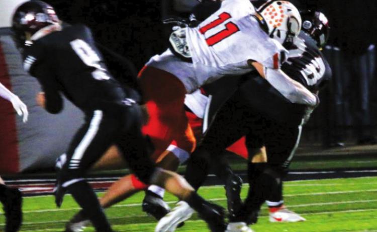 Tiger middle linebacker, senior Hayden Fry, penetrates the Wagoner line untouched and puts a hit on a Wagoner ball carrier. Fry had 13 tackles on the night, with 6 solo. He had an impressive season total of more than 180 tackles.