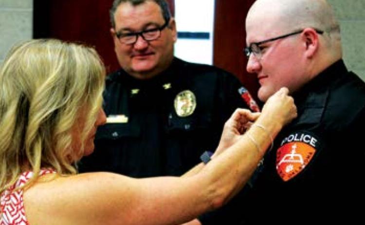 David Smith is pinned by his mother, Jamie Angle.
