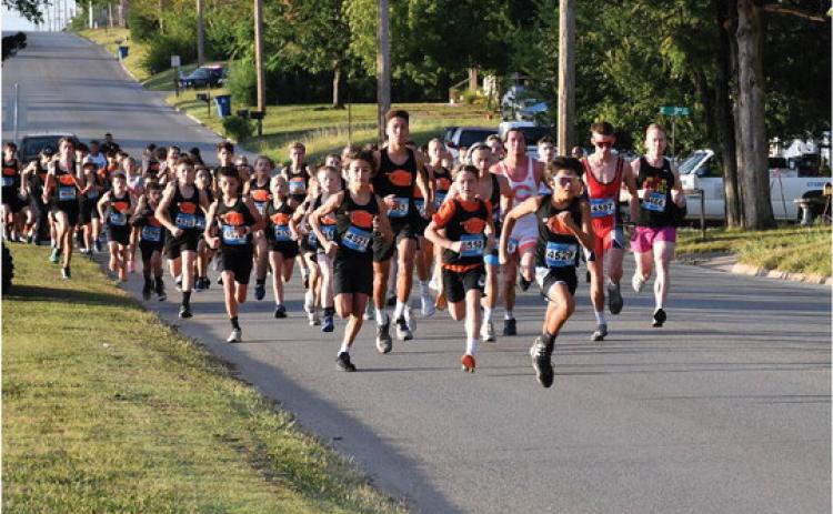 Members of the Cushing Tiger Cross Country team dominate the start of the Grappler’s Gallop Saturday, at Memorial Park. Photo by Sarah Townes