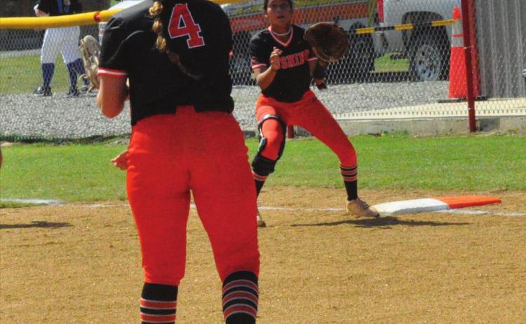 Pitcher Katy Jones makes a throw to Morgan Franklin at first.