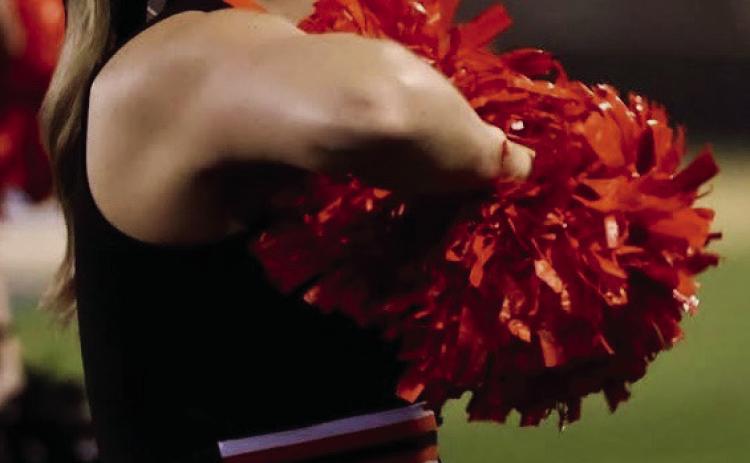 Senior Tiger cheerleader Emery Turner hypes up the crowd during the Friday’s thrashing of Oologah. Photo by Sylvia Danyele