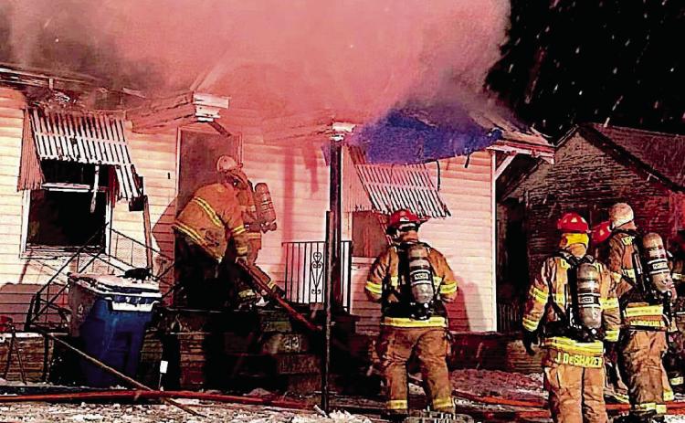 Brett Lunsford and Lucas Andrews makes their way into the primary structure followed by department members Austin Riley, Jesse DeShazer, and Nick Rockhold as billows of smoke ascend and snow descend.