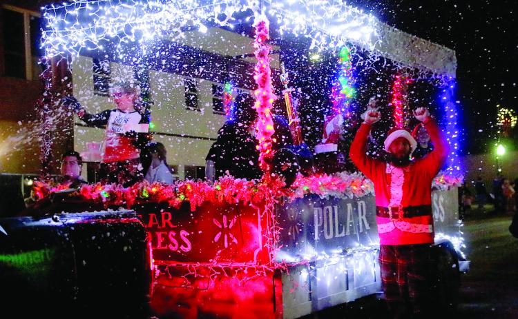 Cushing Wal-Mart associates celebrate their win of Mayor’s Choice in front of the grandstands during the Cushing Christmas Parade Saturday, Dec. 14. Photo by Allie Prater