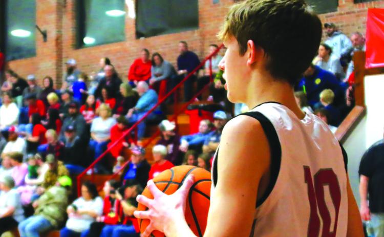 Sophomore Tornado Keaton Jensen looks to inbound the ball in front of a packed house during “I Played at the Brick” night last Friday. All Tornado alumni who played at Drumright’s historic arena were invited to be a part of the final high school basketball game to be played in The Brick and they responded, packing the house with a standingroom-only sea of red. Photo by J. D. Meisner