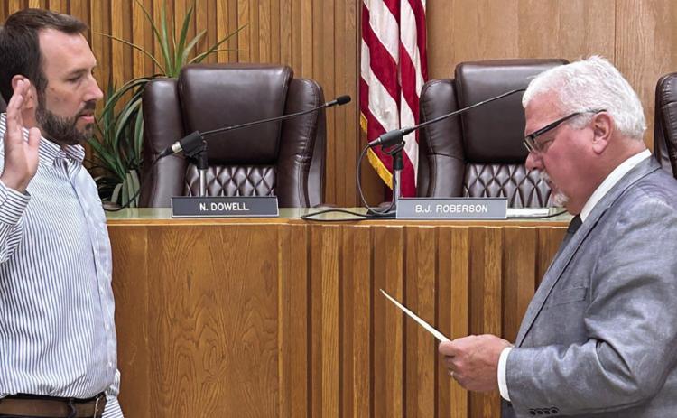 Municipal Judge Bill Ahrberg swears in Cushing City Commission Chairman B. J. Roberson during the regular meeting Monday. Photo by DeAnna Maddox