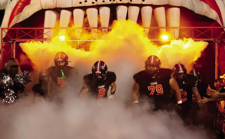 Lane Simpson, Jordan Kersey, and Tye Lucio emerge from the fog, leading the Tigers onto the field Friday for the last regular season home game. Photo by Sylvia Danyele.