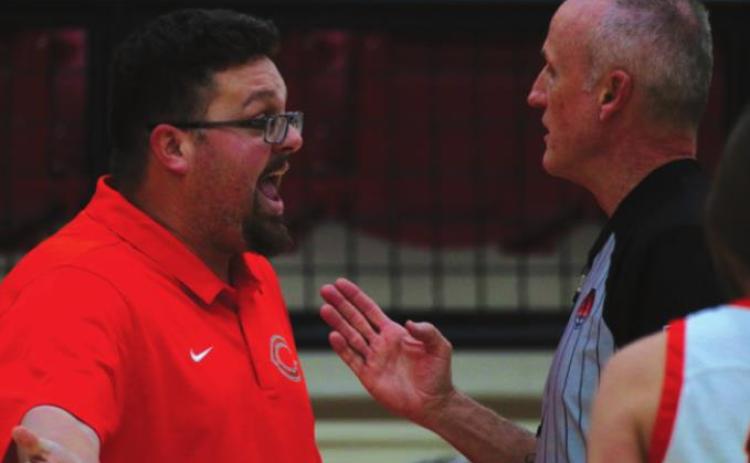 Lady Tiger Head Coach Jake Phillips discusses the fi ner points of putting air in your whistle with a game offi cial during the opening round of the Cleveland Tournament.