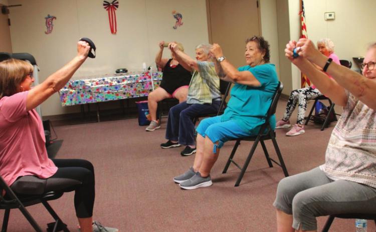 Debbie Brown demonstrates for the participants of Tuesday morning exercise. From right; Vickie Carr, Gloria Aguayo, Mareta Ryan, and Donna Lann in front with Barbara Baker in background.