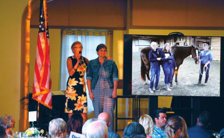 Leslie Kirkland stands hand in hand with Julie Jones as she thanks her for putting in so much time and effort into her work at The Right Path and in coordinating the 25th Anniversary Fundraiser Gala on Saturday, July 24.