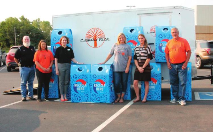 From left stands Chris Hubbard, Laura Green, Dr. Melissa Amon, Brook Holcomb, Jessica Wood, and Richard Thackray with the recycle lend bins that will be dispersed across the Cushing Public Schools property in an eff ort to promote recycling.