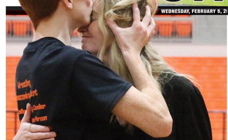 CHS Wrestling senior Owen Collier gives his mom Annie Collier a kiss on the forehead during the CHS Wrestling Senior Night festivities Tuesday, Jan. 28. Photo by Allie Prater