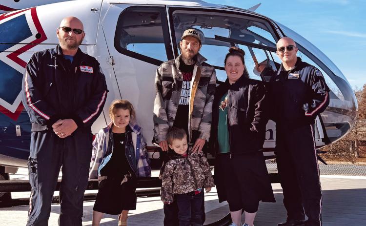 Myles Dobson and his family recently visited the MedFlight crew who transported and provided critical care to him during a flight from Stroud to OSU Medical Center in Tulsa recently. Pictured with Dobson and his family are flight nurse Matt George and Flight Paramedic Chase Boyd.