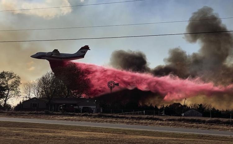A tanker plane drops Phos-Chek, a fertilizer-based liquid and fire suppressant, on the flames near Schlegel Road. Photo courtesy Jordan Stebens